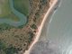 aerial view of green grass field beside body of water during daytime